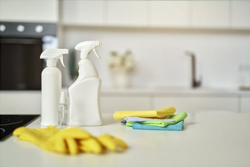 Freshly cleaned kitchen counter with cleaning supplies, Andean Cleaning Solutions